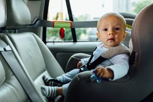 Child safely seated in a limo car seat, highlighting kids' transportation service in Chicago.
