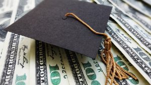 a graduation toga above the dollars for free college scholarship
