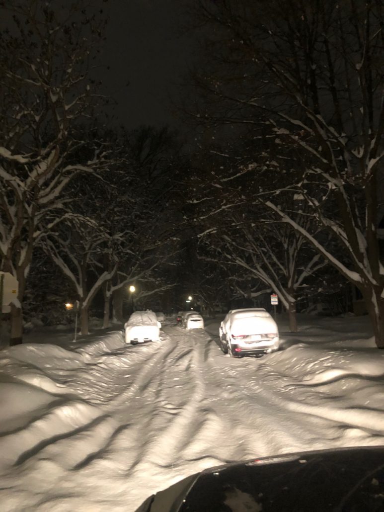 snowstorm suv limo service on a snowy road at night