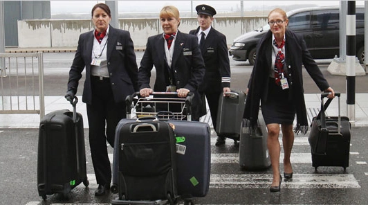 Airline crew walking with luggage on airport grounds supported by Airline Crew Transportation Chicago