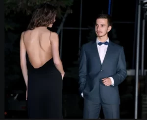 Man in a suit looking at a woman in a backless black dress after arriving in a fundraiser limo service