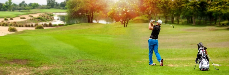 A golfer takes a swing on a course, illustrating the need for reliable Golf Transportation Chicago.